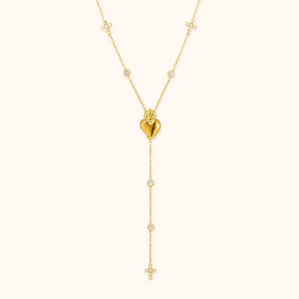 Gold heart zircon Y necklace on a warm cream background