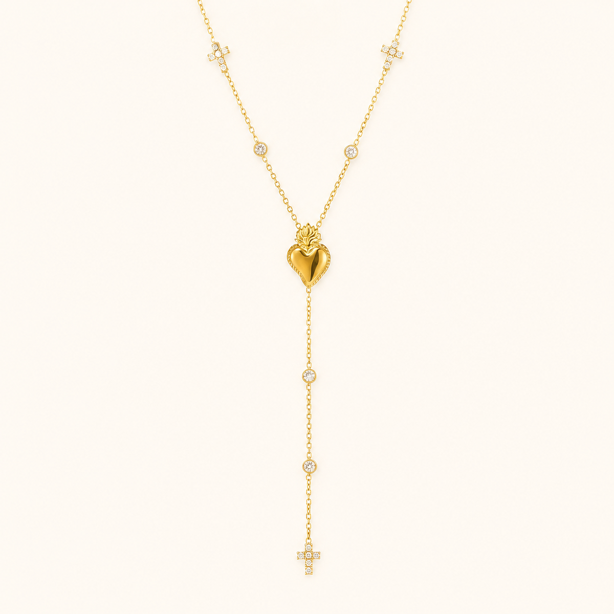 Gold heart zircon Y necklace on a warm cream background