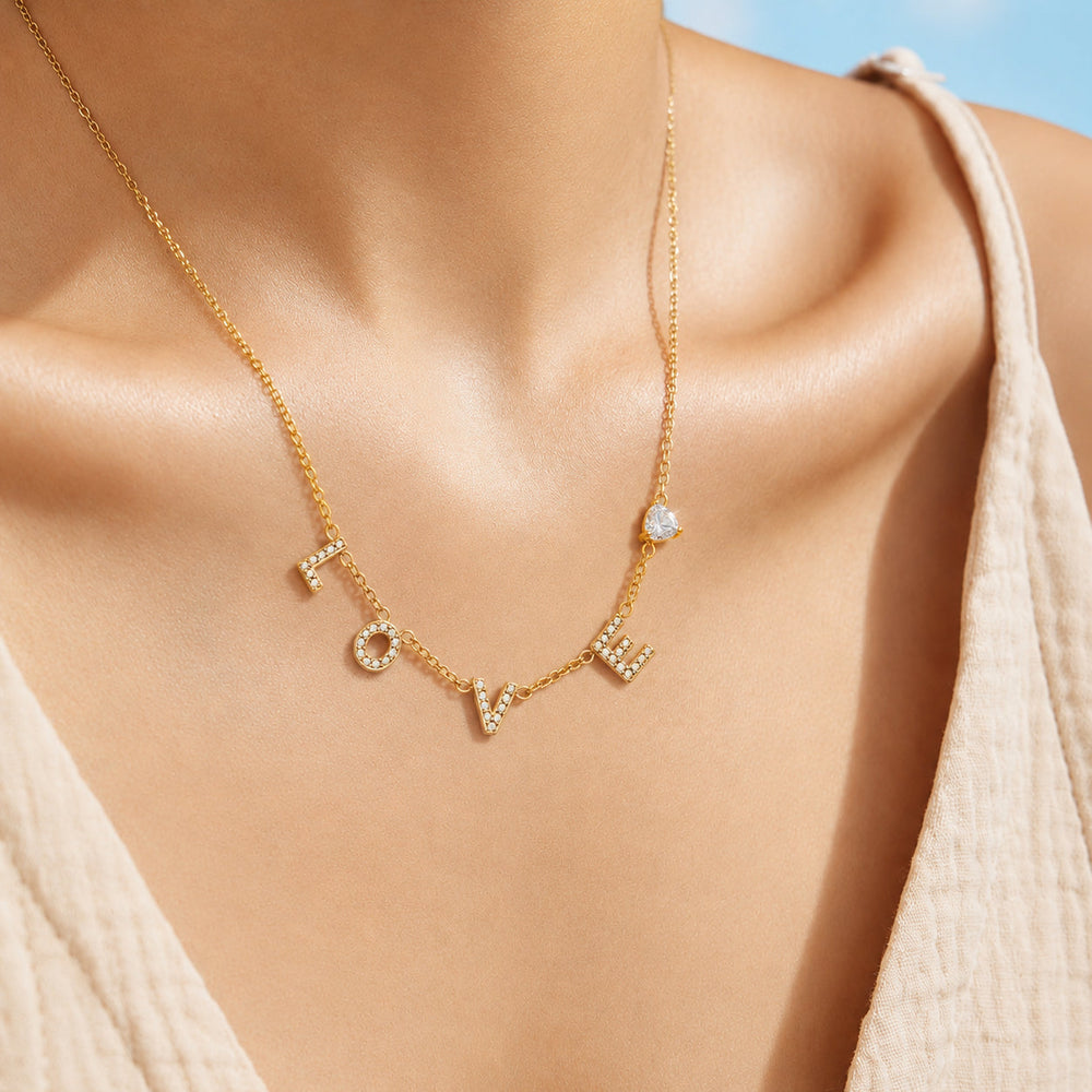 Model wearing the gold LOVE letter zircon necklace