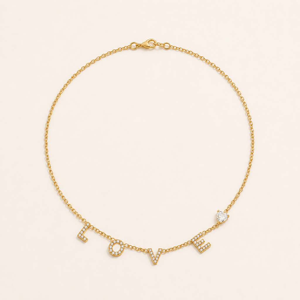 Gold LOVE letter zircon necklace on a warm cream background