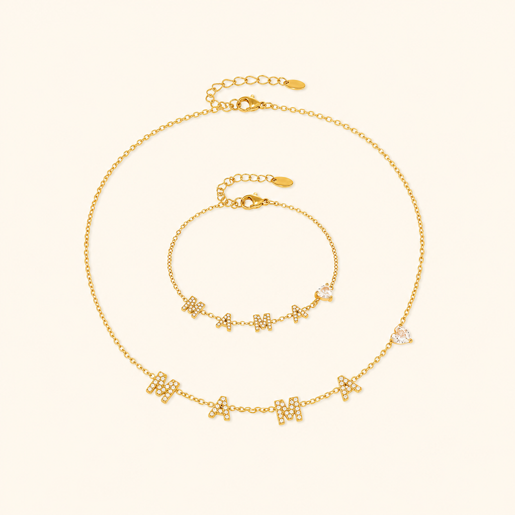 Gold MAMA heart zircon necklace and bracelet on a warm cream background