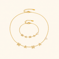 Gold MAMA heart zircon necklace and bracelet on a warm cream background