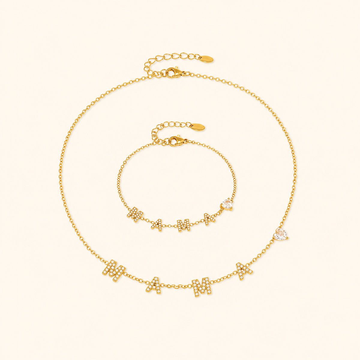 Gold MAMA heart zircon necklace and bracelet on a warm cream background