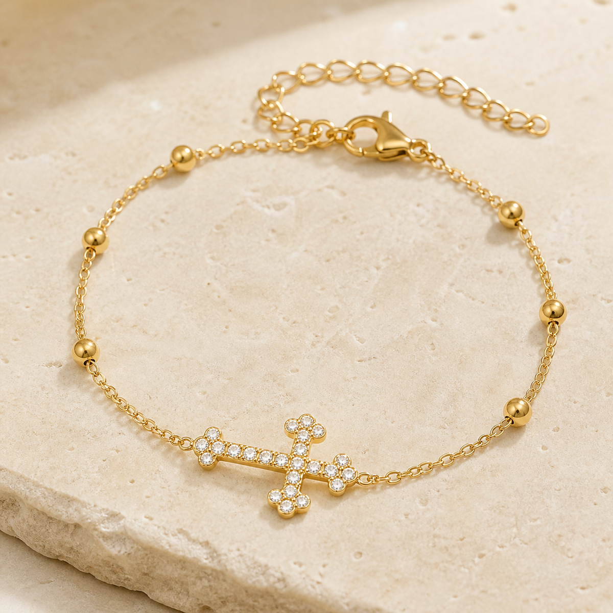 Grace Zircon Cross Bracelet close-up on ivory stone