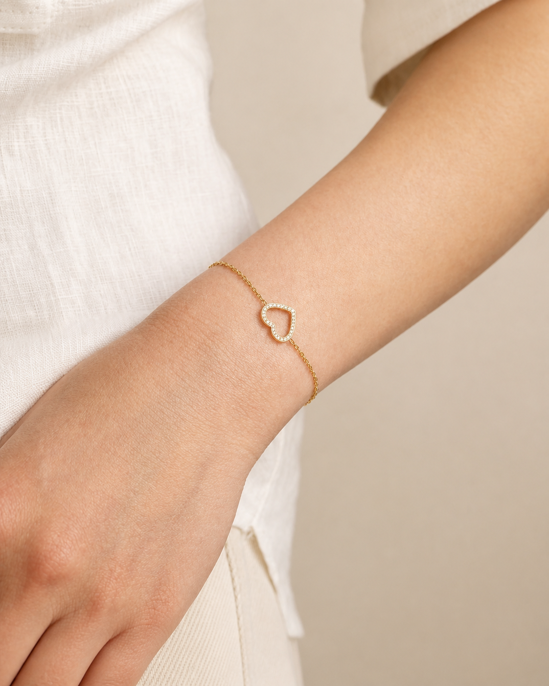 Model wearing the gold Promise Heart Bracelet